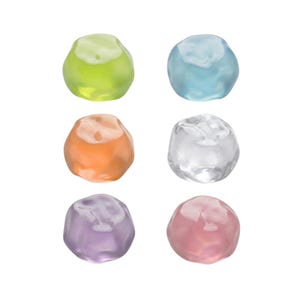 May include: A set of six small, rounded, translucent objects with irregular, organic shapes. The colours include lime green, light blue, peach, clear, lavender, and soft pink. Each piece has a smooth, glossy surface with subtle indentations.