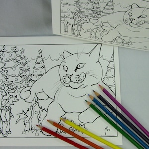 May include: A black and white coloring page featuring a cat sitting in front of two Christmas trees with a reindeer and a person standing next to the trees.  There are six colored pencils on the white surface.