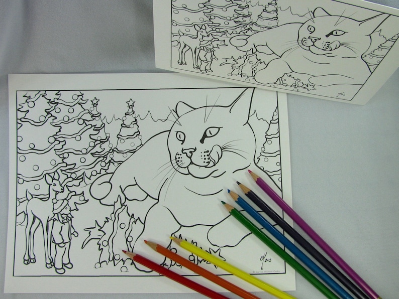 May include: A black and white coloring page featuring a cat sitting in front of two Christmas trees with a reindeer and a person standing next to the trees.  There are six colored pencils on the white surface.