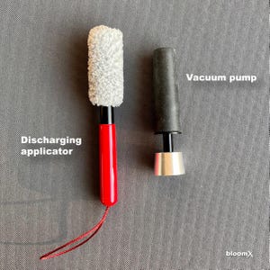 May include: A red and black discharging applicator with a white fluffy tip and a black and silver vacuum pump.