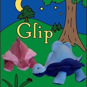 May include: Two plush turtle toys, one pink and one blue, are sitting on a green grassy field under a starry night sky. The word "Glip" is written in yellow letters on the hill behind the turtles. A ladybug is sleeping on a blade of grass.