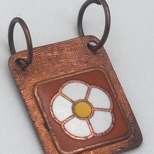 May include: A white ceramic mug with a black handle and the text "But First, Coffee" in a black, bold font. The mug is on a white surface.