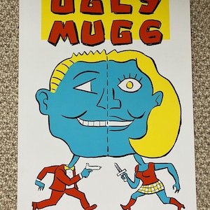 May include: A colourful illustration of a split face with the text "UGLY MUGG" above it. The face is split down the middle, with one side blue and the other yellow. The blue side has a man's face with a yellow eye and the yellow side has a woman's face with a blue eye. Below the face, a man in a red suit and a woman in a red dress are running towards each other, the man holding a gun and the woman holding a knife.