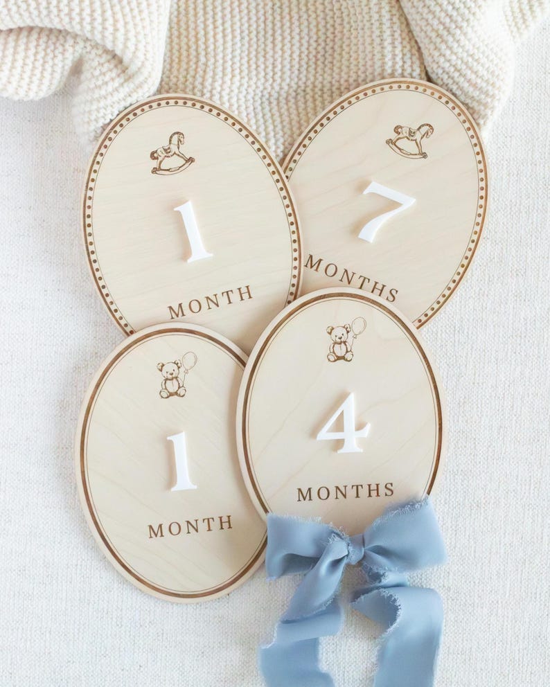 Neutral wooden baby month milestone markers styled for newborn and infant photography. Monthly photo prop used to show baby age progression and growth milestones during the first year. Teddy bear nursery decor works for baby boy or gender neutral nurseries. Popular baby shower gift, first year photo keepsake, wooden milestone plaques for monthly baby pictures.
