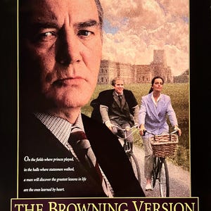 May include: Movie poster for "The Browning Version" starring Albert Finney, Greta Scacchi, and Matthew Modine. The poster features a close-up of Albert Finney's face, with Greta Scacchi and Matthew Modine riding bicycles in the background. The poster has a dark background with yellow text.