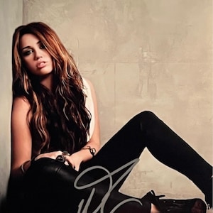 Miley Cyrus original autographed photo - framed