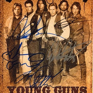 May include: A sepia-toned poster featuring a group of men in Western attire. The image is signed by multiple people. The text "YOUNG GUNS" is printed in a brown, Western-style font at the bottom of the poster.