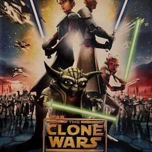 May include: A movie poster for Star Wars: The Clone Wars. The poster features Yoda, Obi-Wan Kenobi, Anakin Skywalker, and Ashoka Tano. The text on the poster reads "Star Wars: The Clone Wars" and "In Theaters August 15".