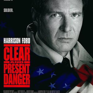 May include: A movie poster for the film "Clear and Present Danger" starring Harrison Ford. The poster features a close-up of Ford's face, with the American flag in the background. The text "Truth needs a soldier." is at the top of the poster, and the title of the film is in large, red letters.