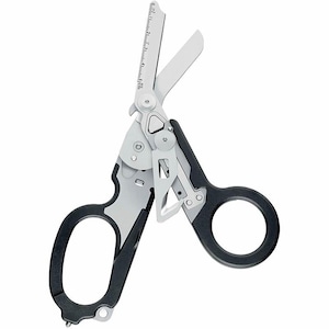 May include: A pair of silver and black folding trauma shears featuring a ruler printed on one blade that measures up to 5 cm. The tool includes a central pivot mechanism, a small hook-shaped blade, and two large finger loops with black grips.