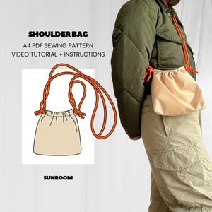 May include: A digital illustration of a shoulder bag with orange straps. The bag is a simple drawstring design. The text "SHOULDER BAG" is at the top of the image. Below the bag is the text "A4 PDF SEWING PATTERN VIDEO TUTORIAL + INSTRUCTIONS" and the text "SUNROOM".