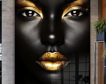 May include: A close-up of a black and gold abstract art print featuring a woman's face with bold makeup. The woman's lips are painted a bright gold color.