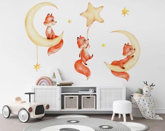 May include: Three watercolor fox illustrations on a white wall. The foxes are orange and white and are sitting on yellow crescent moons. One fox is holding a yellow star balloon. The illustrations are perfect for a nursery or child's room.