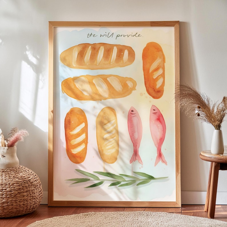May include: A framed watercolour print depicting several loaves of bread, two pink fish, and a sprig of green leaves. The text "he will provide" is written across the top. The artwork has a light, airy feel with soft colours.