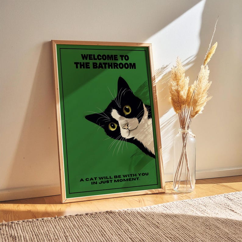 Funny tuxedo cat bathroom print — green framed decorative poster with a black-and-white cat; perfect restroom wall art for cat lovers.