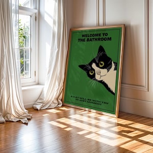 Funny tuxedo cat bathroom print — green framed decorative poster with a black-and-white cat; perfect restroom wall art for cat lovers.