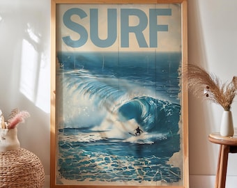 May include: A rectangular framed wall art print featuring a large blue ocean wave with a surfer riding it. The word SURF is printed in large, light blue capital letters across the top. The artwork has a vertical wood plank texture throughout.