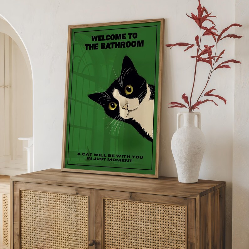 Funny tuxedo cat bathroom print — green framed decorative poster with a black-and-white cat; perfect restroom wall art for cat lovers.