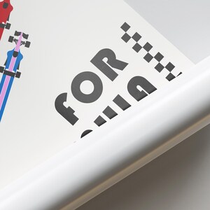 May include: Close-up of a white poster with the word "FOR" in large black letters. The poster also features a stylized illustration of a musical instrument in red, blue, and pink. A white, rolled edge is visible.