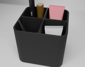 May include: A black, compartmentalized organizer holding beauty products. The organizer contains a black nail polish bottle with the word "NAIL" printed on it, a gold tube, a pink tube, a white tube, and a pair of tweezers.