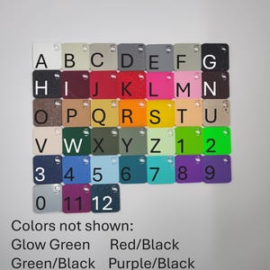 May include: A collection of small, square acrylic color swatches, each with a letter or number. Colors include white, black, red, pink, and various shades of blue, green, and yellow. The text "Colors not shown" lists additional color options.