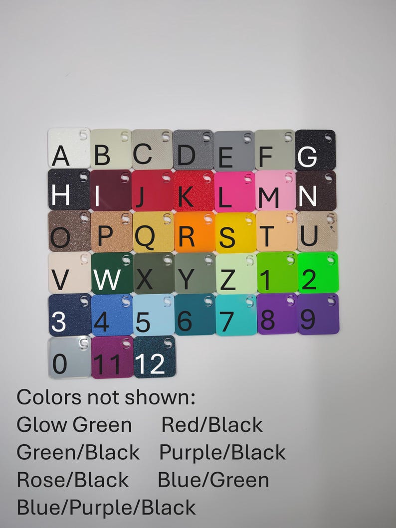 May include: A collection of small, square acrylic color swatches, each with a letter or number. Colors include white, black, red, pink, and various shades of blue, green, and yellow. The text "Colors not shown" lists additional color options.