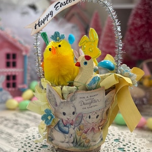 May include: An Easter basket with a yellow chick, a yellow bunny, and a small bird. The basket has a banner that says "Happy Easter!" and a label that says "For a Sweet Little Daughter on Easter."