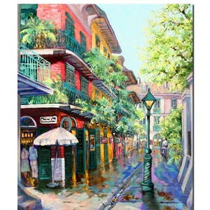 Print view of a vibrant New Orleans French Quarter scene, Pirates Alley is depicted with colorful buildings adorned with balconies and lush greenery.