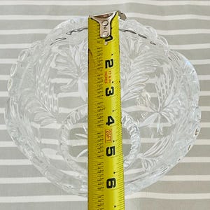Peut inclure: Bol en verre transparent avec un motif floral d&eacute;coratif. Le bol mesure environ 12,7 cm de diam&egrave;tre, mesur&eacute; par un m&egrave;tre ruban jaune. Le bol a un bord festonn&eacute;.