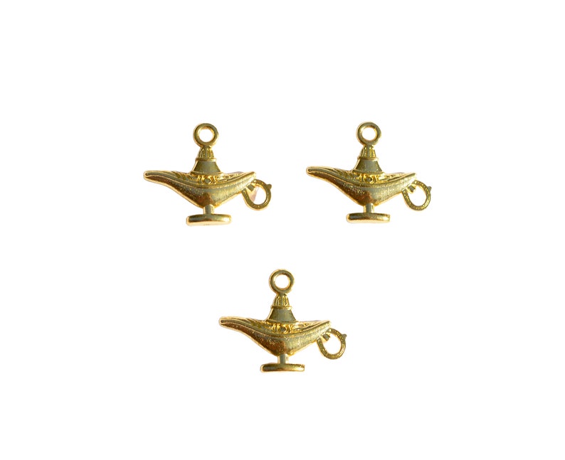 May include: Three gold-coloured genie lamp charms with a loop for attaching to a necklace or bracelet.