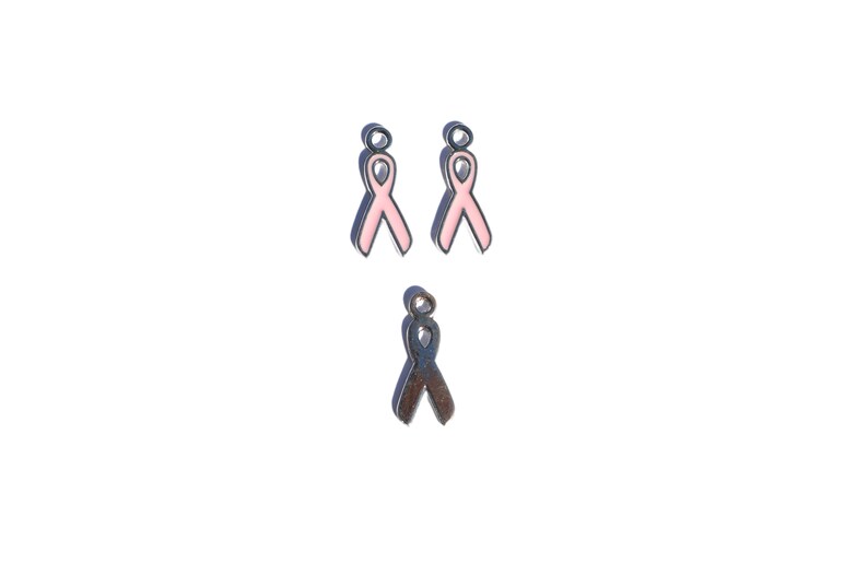 May include: Three metal ribbon charms, two pink and one silver. The pink ribbons are enamel and the silver ribbon is plain metal.