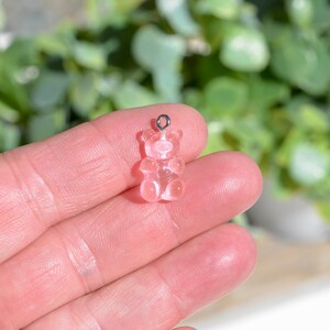 May include: A pink gummy bear charm with a silver loop for attaching to a necklace or bracelet.
