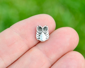 May include: Silver owl charm with a detailed design. The owl has large eyes and a round body.
