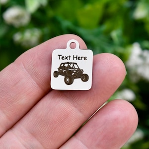 May include: White wooden square tag with a black silhouette of an off-road vehicle and the text "Text Here".