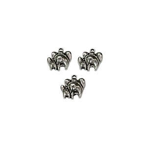 May include: Three silver charm pendants shaped like elephants, each with a smaller elephant standing behind a larger elephant.