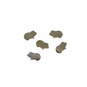 May include: Five silver-colored metal charms shaped like guinea pigs. The charms are all facing the same direction and have a slightly textured surface.