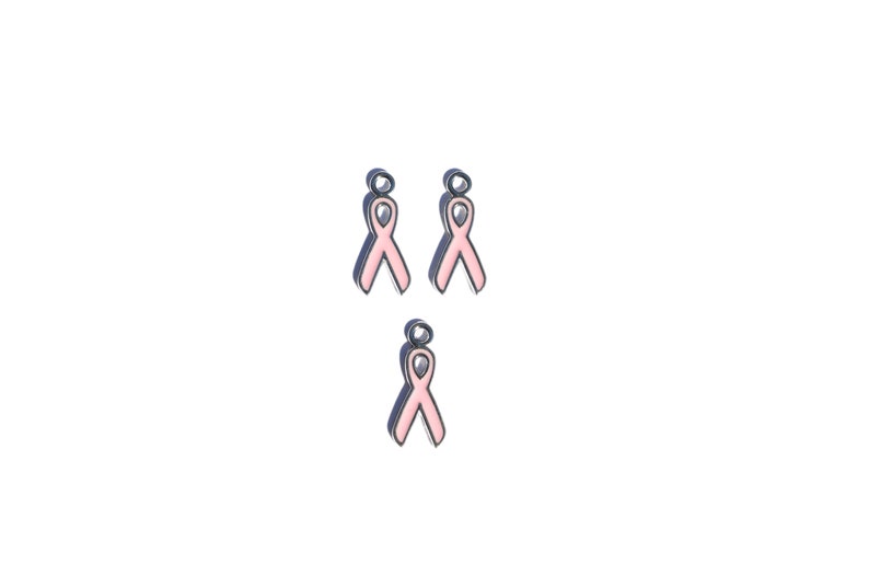 May include: Three pink ribbon charms with a silver finish. The charms are designed to be used on jewelry or other crafts.