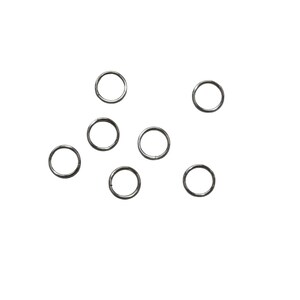 May include: A set of ten silver jump rings, scattered on a white background.