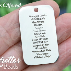May include: A silver metal tag with a list of fonts offered, including Monotype Corsiva, Old English, One Stroke, Papyrus, Park Avenue, Cuigley Wiggly, Rage Halic, Script MT Bold, Scruff LET Plain, Sapudser LET Plain, Firanti Solid, Victorian LET Plain, Vivaldi Fradic, and Vladimir Script.
