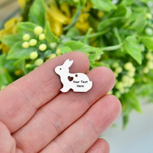 May include: A silver metal charm shaped like a rabbit with a heart cut out. The charm has the text "Your Text Here" engraved on it.