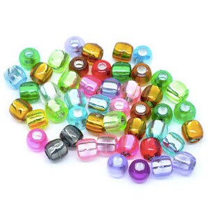 May include: Assortment of colorful, translucent plastic beads. The beads are round and have a hole in the center. They are perfect for jewelry making, crafts, and other projects.
