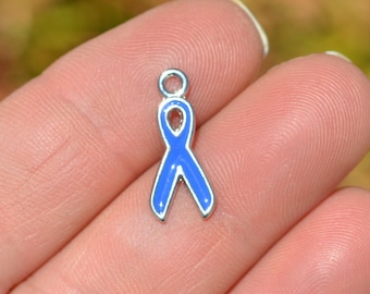 May include: A silver charm in the shape of a blue ribbon. The ribbon is a symbol of awareness and support for various causes.
