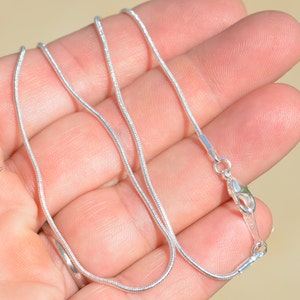Puede incluir: Un collar de cadena de serpiente de plata con cierre de langosta.