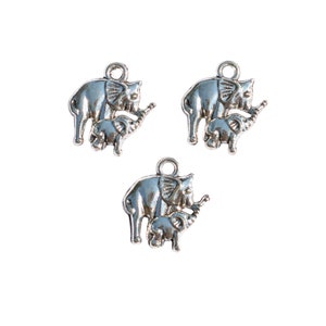 May include: Three silver charm pendants featuring a mother elephant and baby elephant. The elephants are facing right and have detailed features.