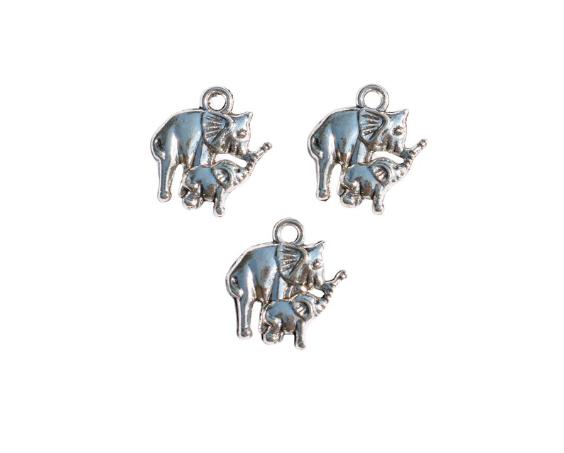 May include: Three silver charm pendants featuring a mother elephant and baby elephant. The elephants are facing right and have detailed features.