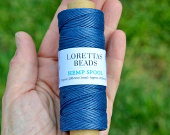 May include: A spool of dark blue hemp cord with a label that reads "Loretta's Beads Hemp Spool 30grams | 20lb test (1mm) Approx. 205ft/62m"
