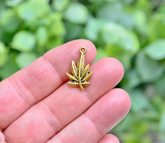 Gold weed leaf pendant deals