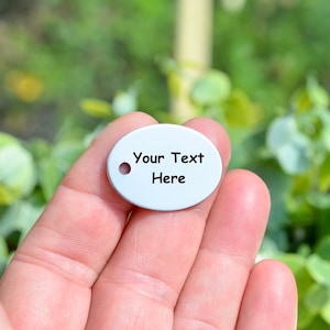 May include: White oval metal tag with a hole for hanging. The tag has the text "Your Text Here" printed on it.