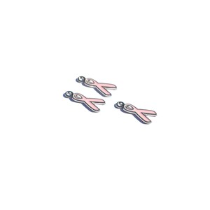 May include: Four pink ribbon charms with silver accents. The charms are designed to be used for jewelry making or other craft projects.