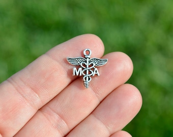 May include: Silver charm with a medical caduceus symbol and the letters "MDA" on a finger.